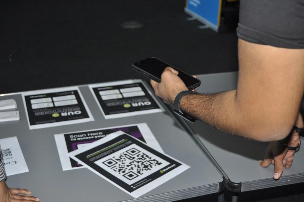 Attendees receiving instant Snapshare photo via QR code at Startup Fair